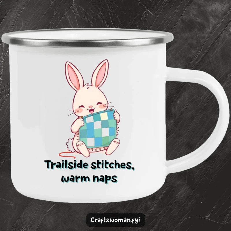 Funny camping mug featuring a joyful rabbit character diligently stitching a tiny patchwork quilt, ideal for outdoor sewing enthusiasts.