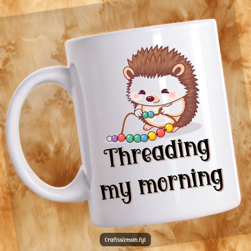 Funny mug showing a hedgehog carefully placing beads onto a string with focused determination, perfect for jewelry makers and crafters.