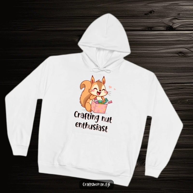 Funny hoodie depicting a delighted squirrel opening a gift box brimming with miniature craft supplies, radiating happiness and creative energy.