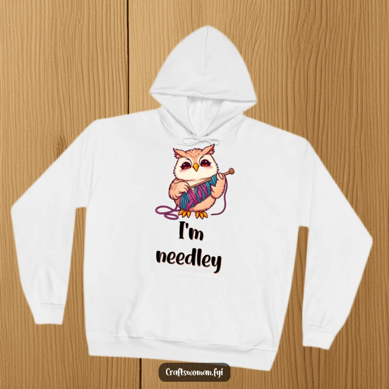 Funny Owl Hoodie showcasing a happy owl expertly threading colorful yarn through a large needle, a cozy gift for crafters.