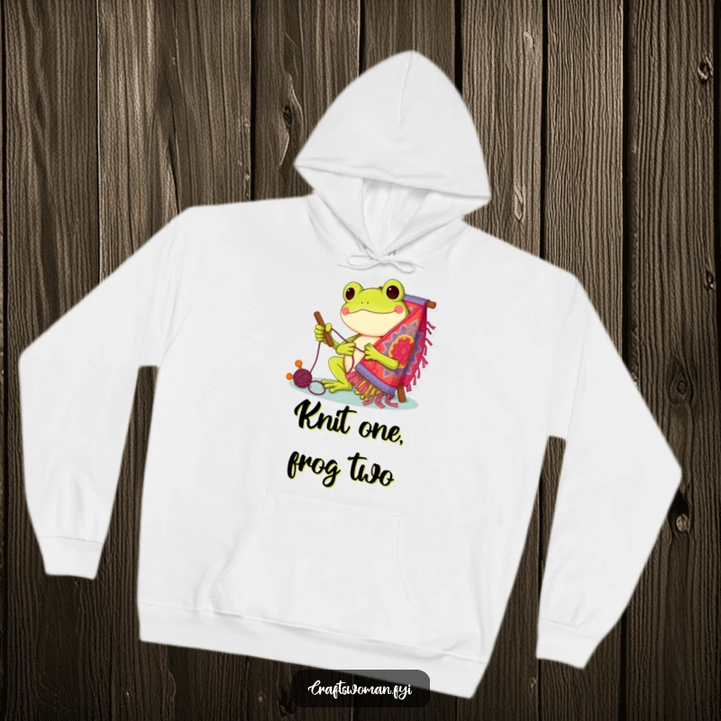 Funny Hoodie: Cheerful frog character engrossed in stitching a vibrant and detailed tapestry, radiating happiness.