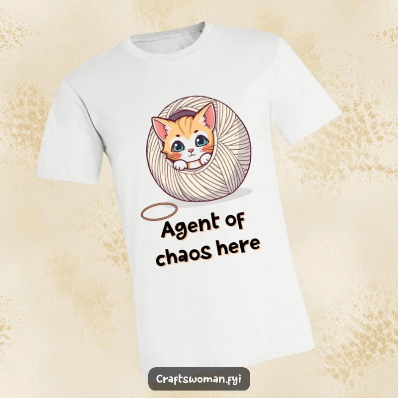 Funny t-shirt featuring a curious cat peeking behind a huge spool of yarn, capturing a moment of playful obsession.