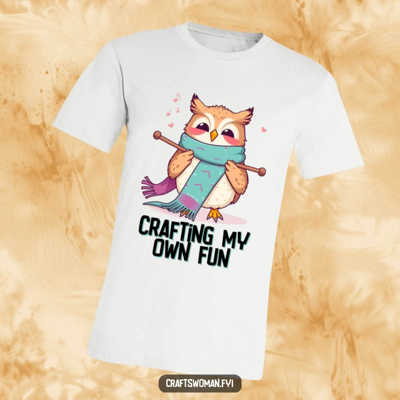 Funny knitting owl t-shirt showing a joyful owl humming while knitting a long, colorful scarf with large needles.
