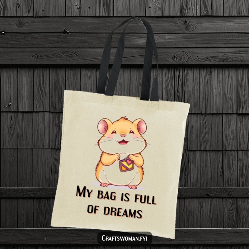 Funny hamster tote bag showing a joyful little character sewing a tiny, colorful patch onto a small garment.
